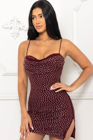 Catch the light when you take our dazzling Amelia  mini for a twirl! She features a form spaghetti straps and side split. The short dress is composed of a rhinestone covered fabric that offers a form-hugging fit with a moderate stretch.