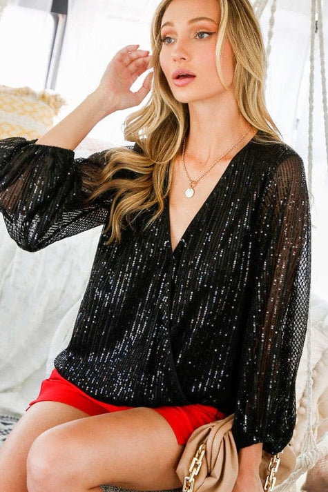 Elegant design , rich color and classic construction throughout make this Malia sequin blouse a guaranteed head turner. Our beautiful V neckline, high and low style top with balloon sleeves is comfortable and breathable. This piece is exclusively for those who aren't afraid to be the center of attention.