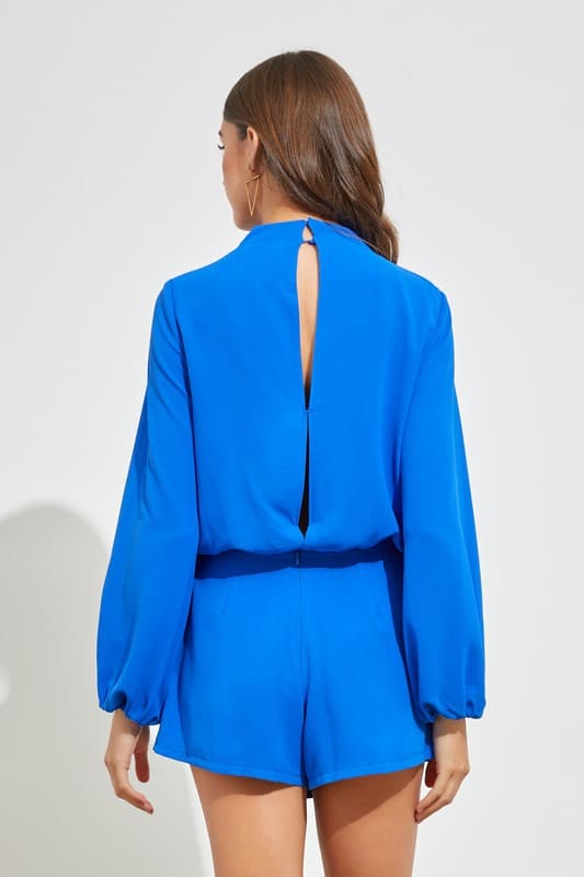 Bring the classic and trendy vibes with this gorgous off white romper! It features a long sleeve bodice, a slightly cowl-neckline with a three gold button accents on one side, a small keyhole cutout below, and shorts with a flowy skirt overlay.