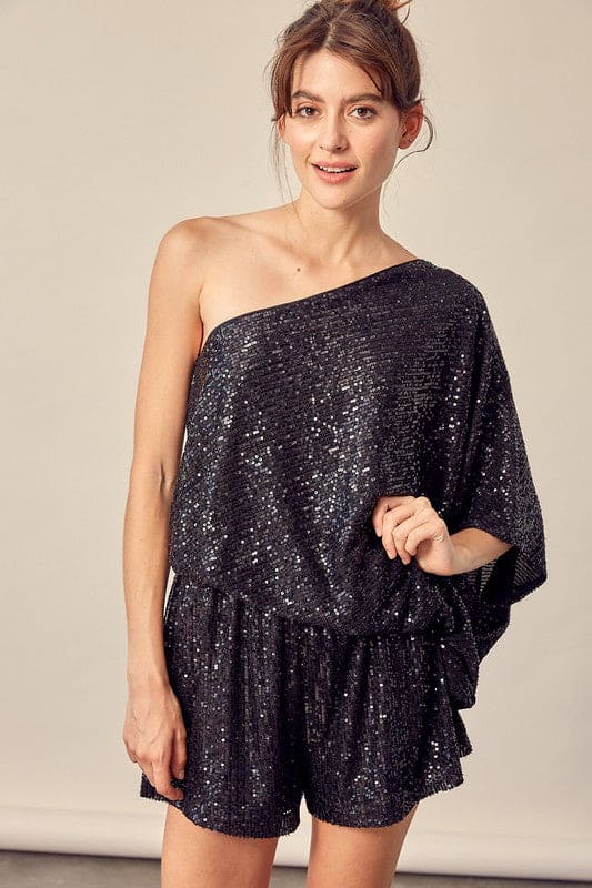 This black party romper is sure to catch a few double-takes with the glistening sequins and attractive silhouette. The cinched natural waist with tie flatters the figure. The draped shoulder style shows off some skin while balancing the billowy sleeves.