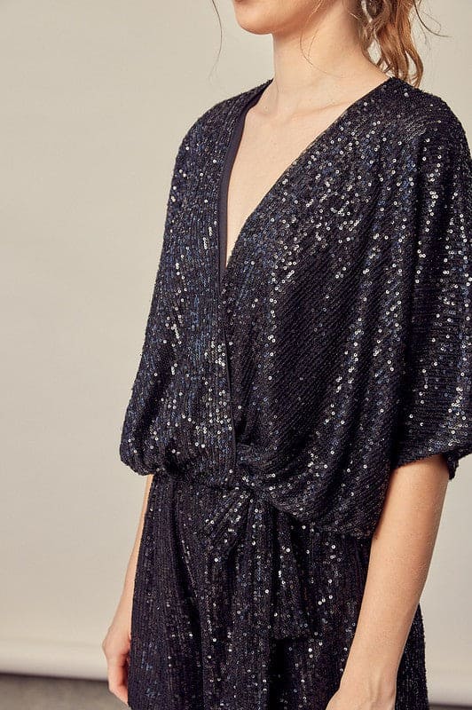 Sequin embroidery, with matching accented belt and meticulously detailed construction. This romper with POCKETS features the right amount of sass for a ton of FUN, FUN,FUN! Side view shows wide comfortable sleeves.www.shopthetags.com