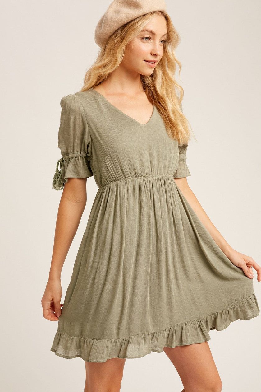 This baby doll style is made from textured woven fabric, fully lined and is cut to a flattering loose fit for a playful yet sophisticated look. Our round-neck babydoll dress featuring puffed sleeves with elastic cuffs with cord accent, 4 buttons on the  back closure and a full, flirty ruffled hem. Wear as is, or add definition to the elasticized waist using a fashionable belt. Now available in ginger - a Classic Style and a staple for every wardrobe. www.shopthetags.com