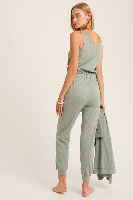 The Nia jumpsuit and cardigan set is back for the Fall season as one of our favorite additions to our loungewear pieces. Nia is a the perfect combination of a sleeveless jumpsuit paired with a long sleeve ,long cardigan with pockets for the complete matching look. This is junior cut, so if you like things on the loose side we suggest sizing up.
