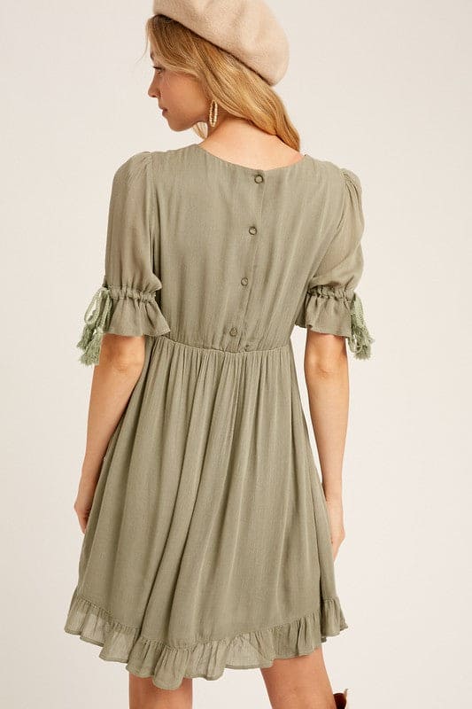Our round-neck babydoll dress featuring puffed sleeves with elastic cuffs with cord accent, 4 buttons on the  back closure and a full, flirty ruffled hem. Wear as is, or add definition to the elasticized waist using a fashionable belt. Now available in ginger - a Classic Style and a staple for every wardrobe. www.shopthetags.com