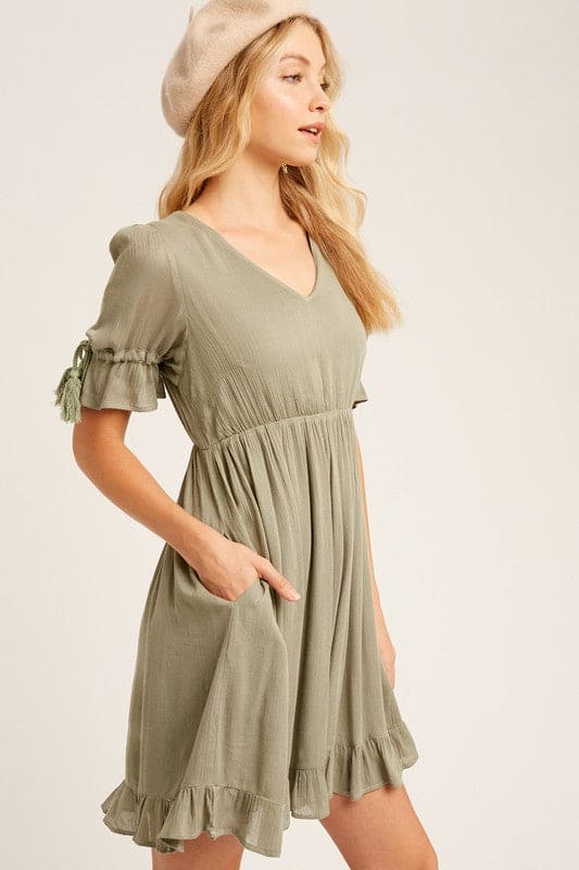 This baby doll style is made from textured woven fabric, fully lined and is cut to a flattering loose fit for a playful yet sophisticated look. Our round-neck babydoll dress featuring puffed sleeves with elastic cuffs with cord accent, 4 buttons on the  back closure and a full, flirty ruffled hem.  This picture shows side pockets.Wear as is, or add definition to the elasticized waist using a fashionable belt.  Classic Style and a staple for every wardrobe. www.shopthetags.com